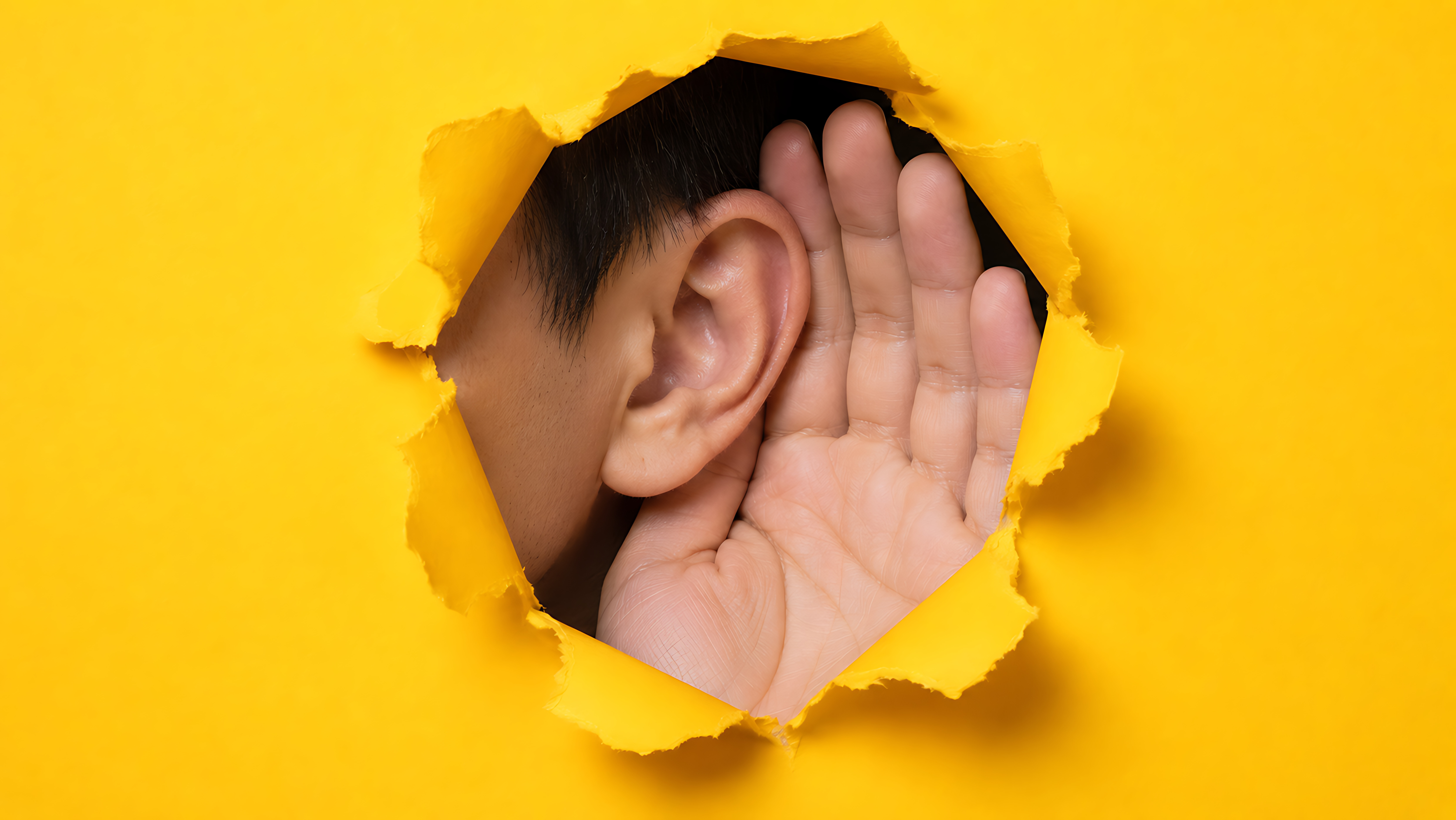 A person cupping their ear to listen — reaching patients through better communication