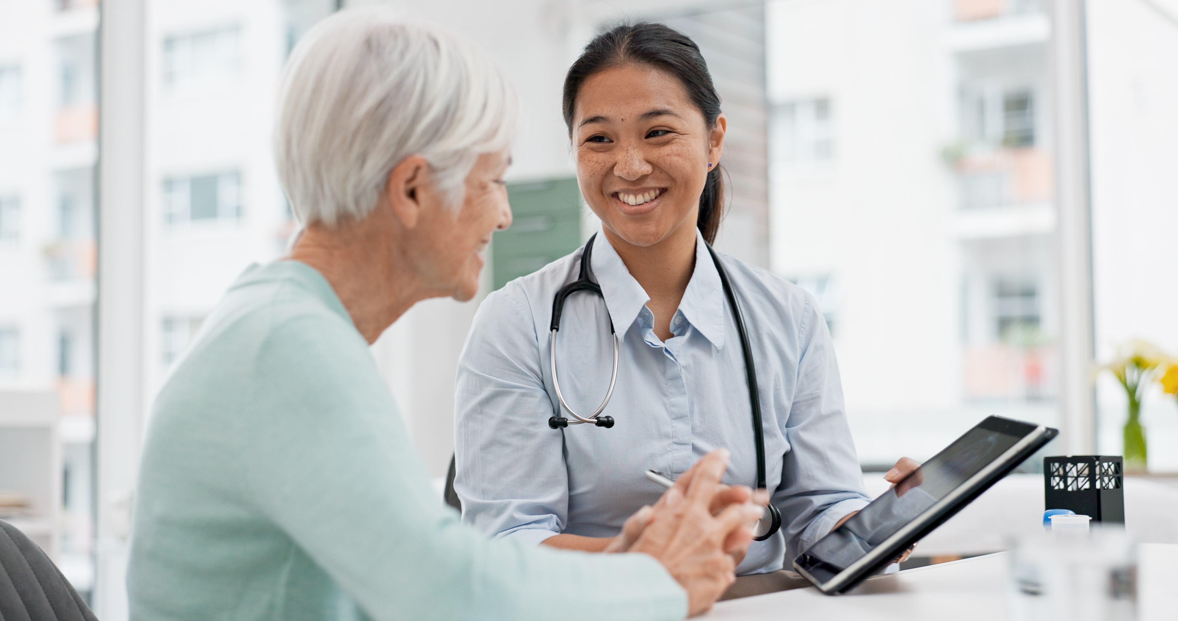 Doctor reviewing patient outcomes and longitudinal data on a tablet